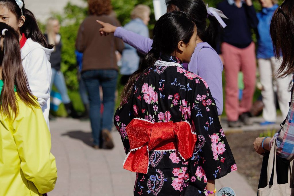A lady in a kimono walks down the village stroll.