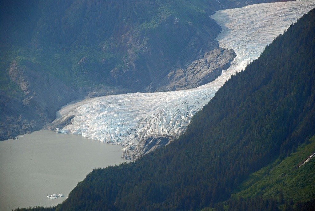 The might Mendenhall Glacier emerges from the mountains and winds down to Mendenhall Lake.