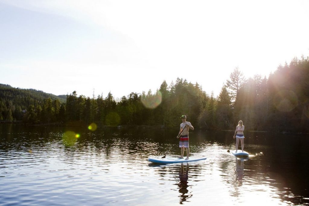 Stand-up paddle boarding on a lake in Whistler.