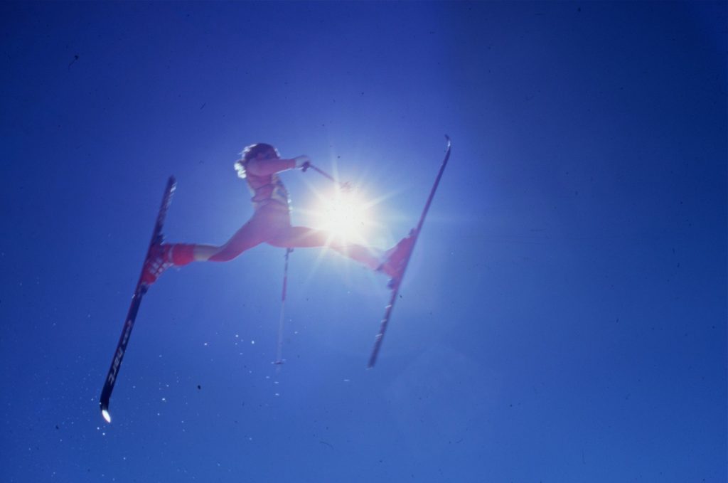 A skier soaring through a blue sky in the 'Dog Days of Winter'.