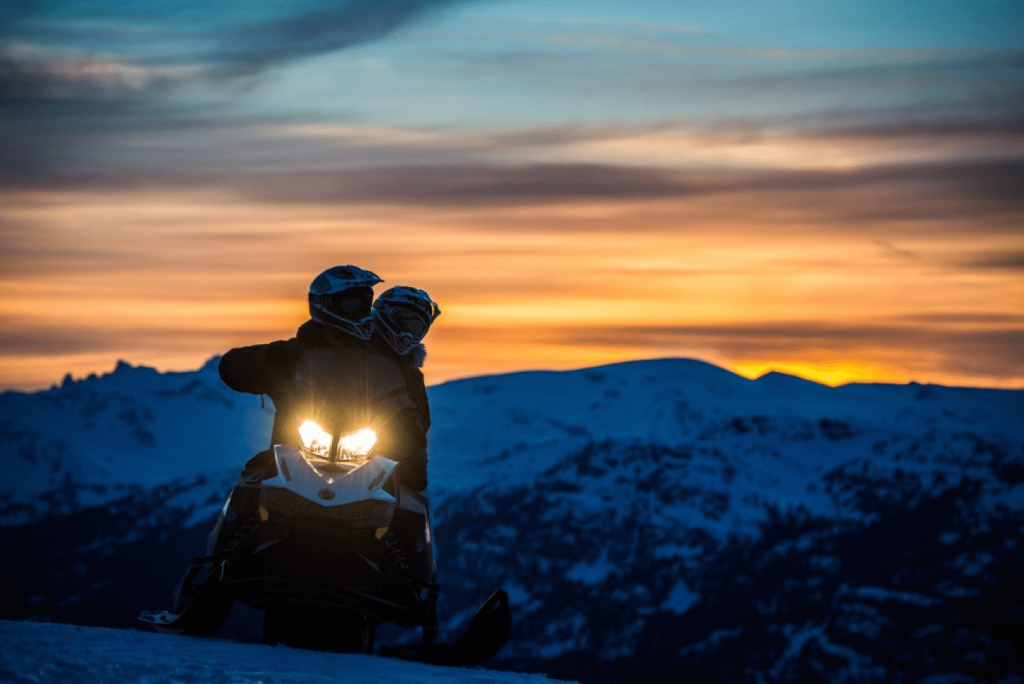 Snowmobiling at sunset.