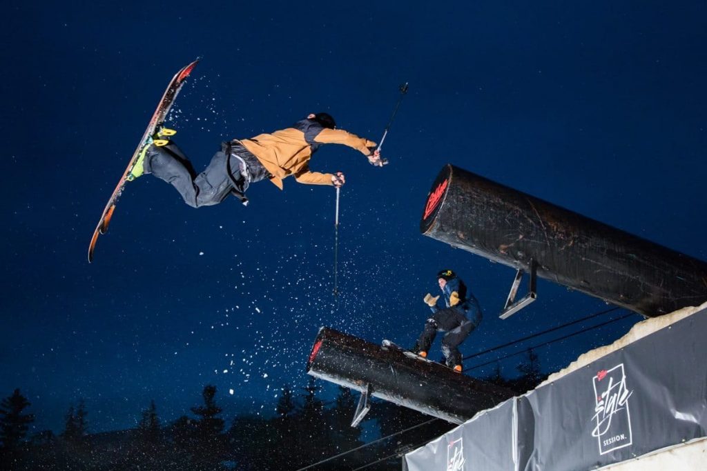 A skier and snowboarder performing a trick during the Gibbons Style Session.
