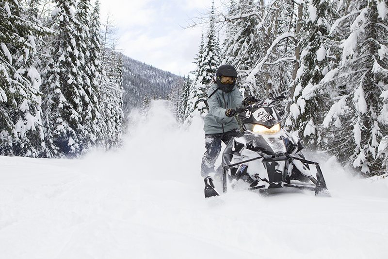 Snowmobiling through the forests of Whistler's backcountry.