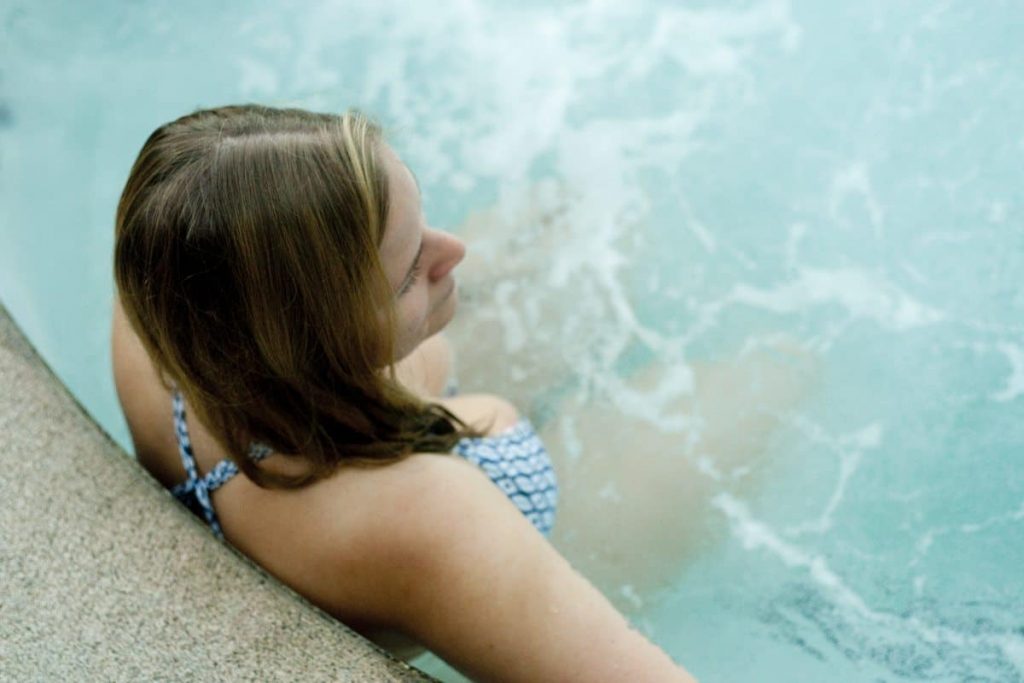 A woman relaxing in a pool at the Scandinave Spa.