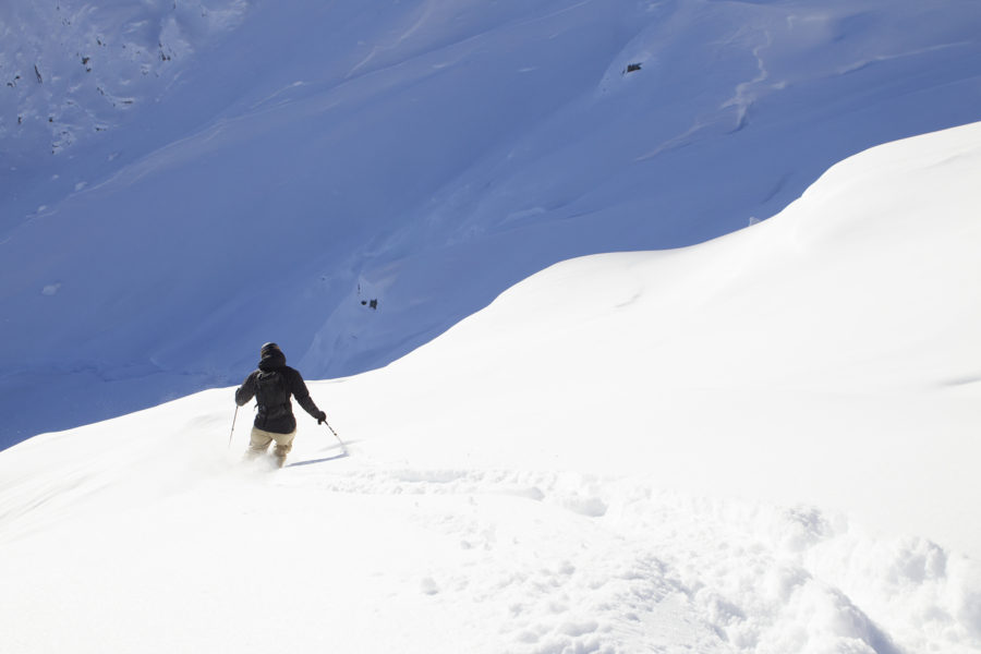 Skiing down powder-filled slopes.