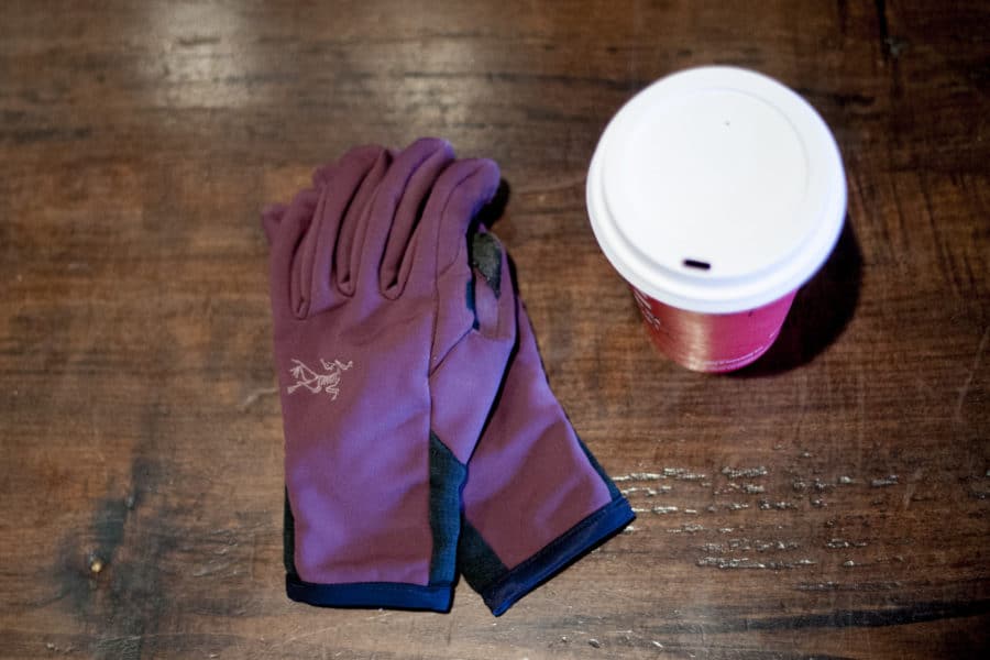 Purple gloves and a cup of coffee.