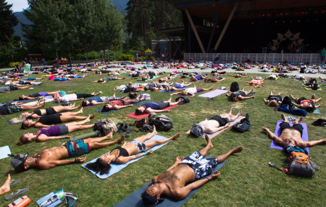 The Whistler Wanderlust crowd participate in collective corpse pose.